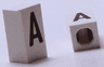 Tile, Modified 1 x 2 x 5/6 Stud Hole in End with Black Capital Letter A Pattern