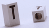 Tile, Modified 1 x 2 x 5/6 Stud Hole in End with Black Capital Letter T Pattern
