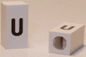 Tile, Modified 1 x 2 x 5/6 Stud Hole in End with Black Lowercase Letter u Pattern