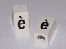 Tile, Modified 1 x 2 x 5/6 Stud Hole in End with Black Lowercase Letter e with Grave (è) Pattern