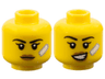 Minifigure, Head Dual Sided Female Black Eyebrows, Single Eyelashes, Medium Nougat Lips, White Bandage, Neutral / Lopsided Open Mouth Smile with Teeth Pattern