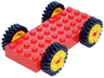 Brick, Modified 4 x 10 with 4 Pins with 4 Yellow Wheel FreeStyle with Technic Pin Hole and 4 Black Tire 24mm D. x 8mm Offset Tread - Interior Ridges (30076 / 6248 / 3483)